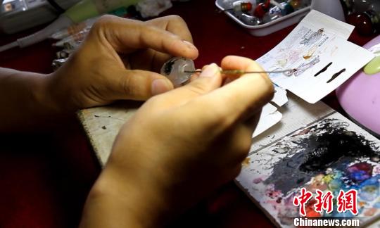 内画非遗传人李国锋用特制的笔在壶内绘画。 张俊 摄 内画非遗传人李国锋用特制的笔在壶内绘画。 张俊 摄